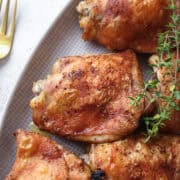 a plate of baked chicken thighs.