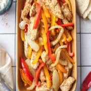 sheet pan chicken fajitas on a platter.
