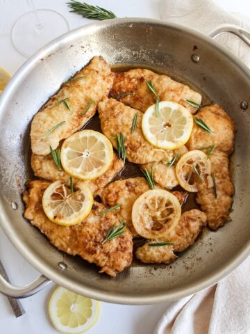 lemony pan seared chicken breasts in a pan