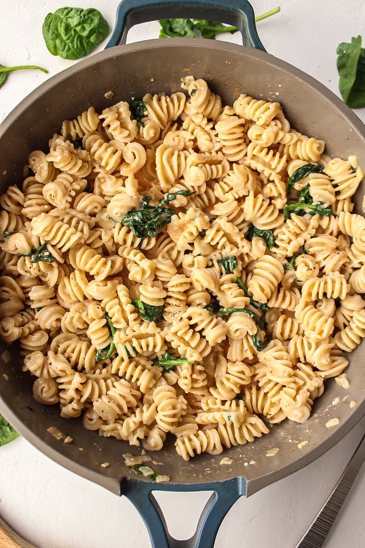 pasta and spinach in a pan