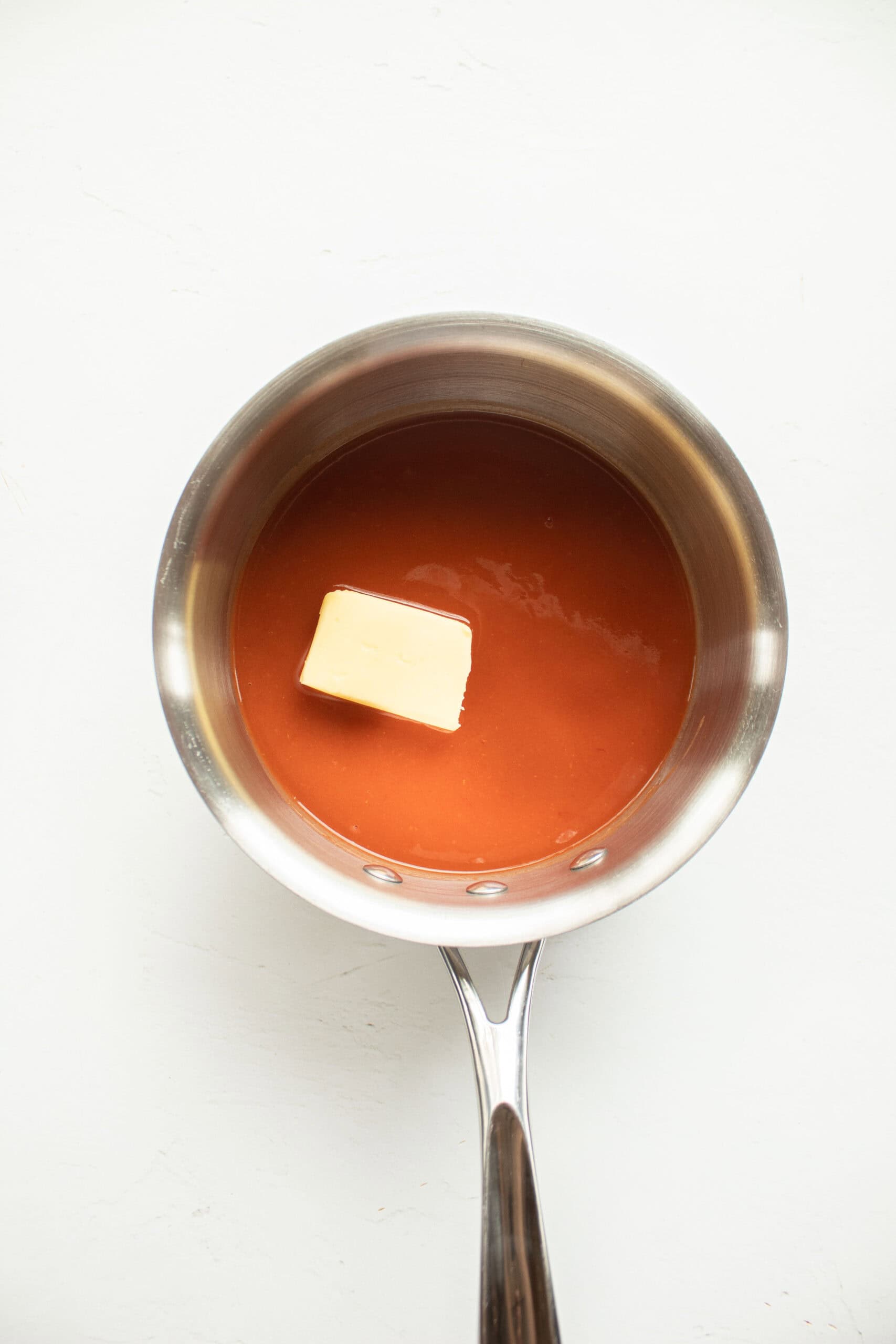 Hot sauce and butter in a sauce pan.