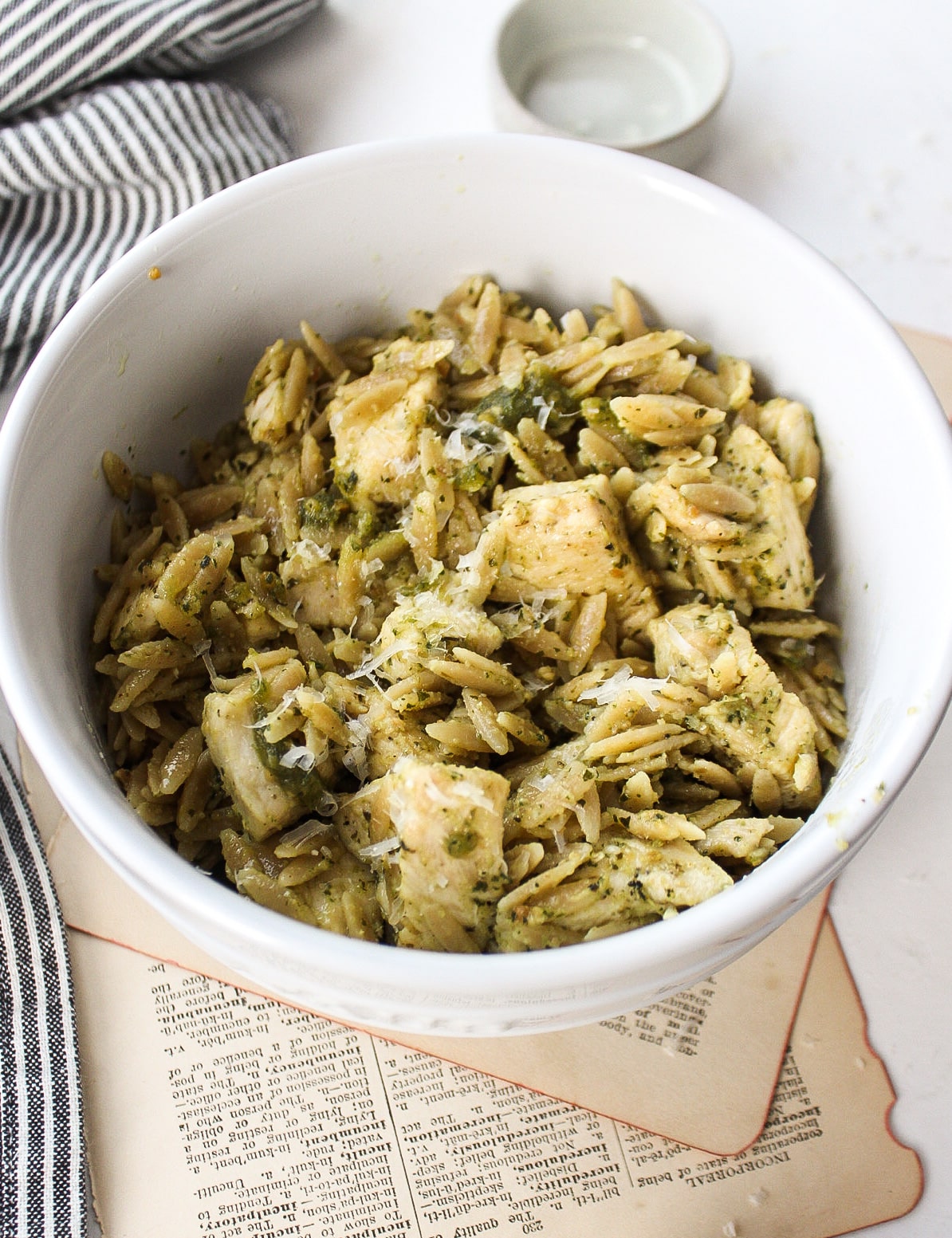 a bowl of pesto orzo with chicken