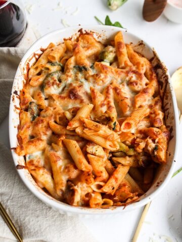 a casserole of baked pasta with vegetables topped with cheese