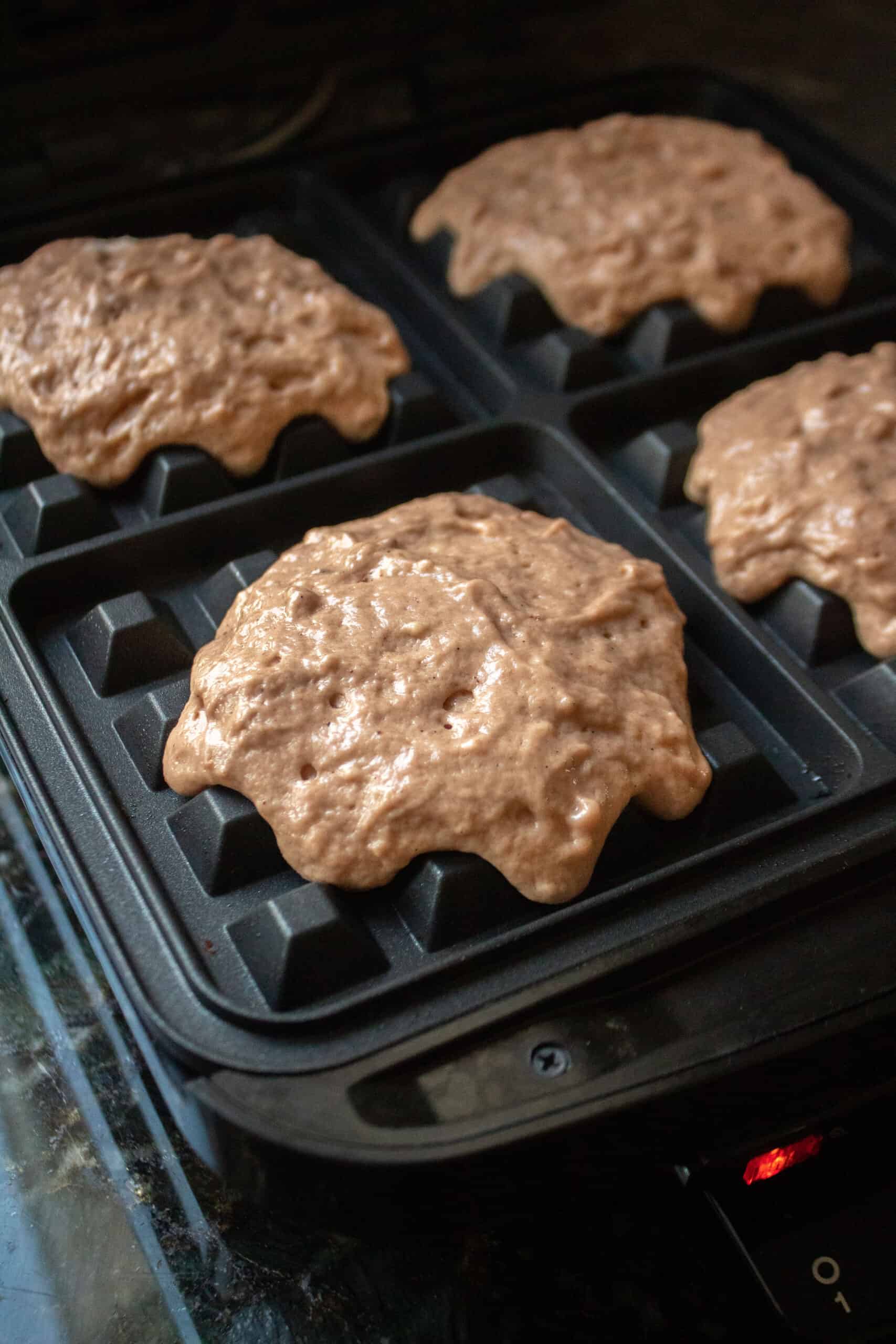 Cocoa buttermilk waffle batter in a waffle iron before cooking.