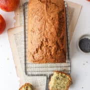 blood orange poppy seed loaf cake on a cooling rack