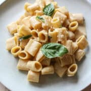 one pot garlic parmesan pasta on a plate with basil garnish.