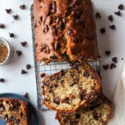a loaf of chocolate chip banana bread with scattered chocolate chips.
