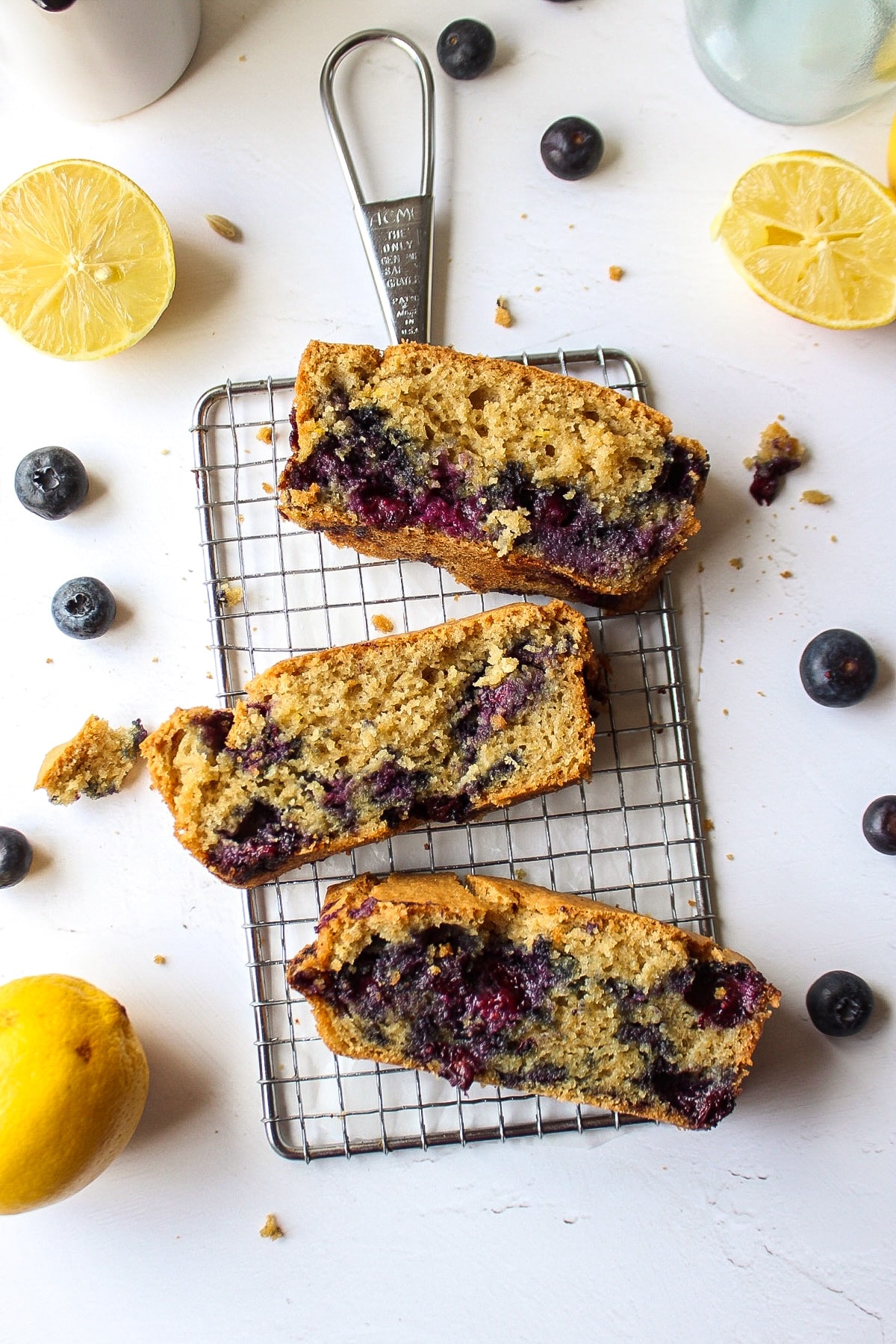 three pieces of lemon blueberry bread on a cooling rack
