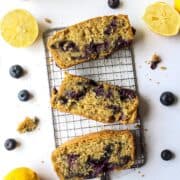 three pieces of lemon blueberry bread on a cooling rack