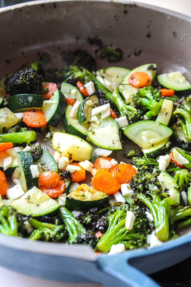 veggies in a pan with garlic and oil
