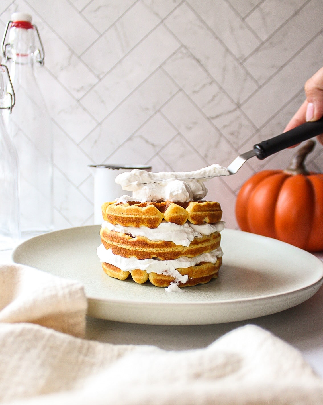 pumpkin waffles staked with whipped cream