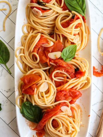 close up of pasta with tomatoes and basil
