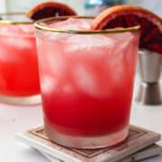 blood orange margarita in a glass with an orange slice