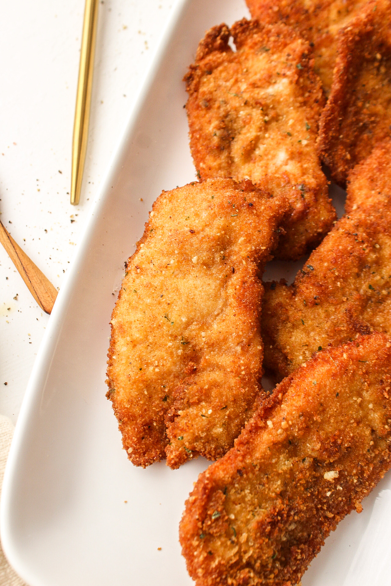 a close up of a breaded and fried chicken cutlet