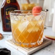glass of sangria with a garnish of apple