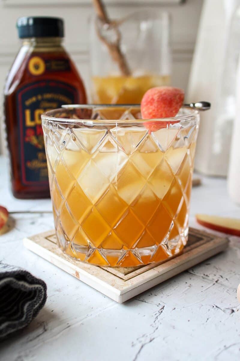 glass of sangria with a garnish of apple