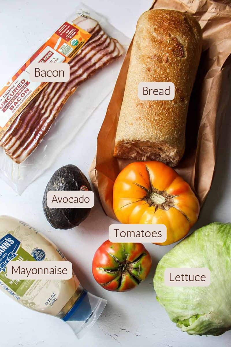 Ingredients to make a BLT with avocado sandwich.