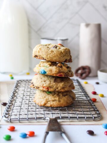 a stack of four cookies on a cooling rack