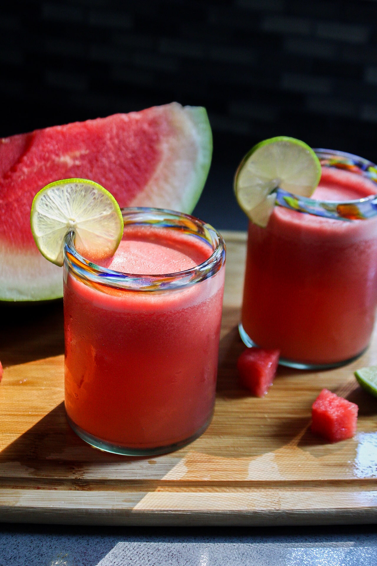 a glass of watermelon frose with a lime slice on the rim