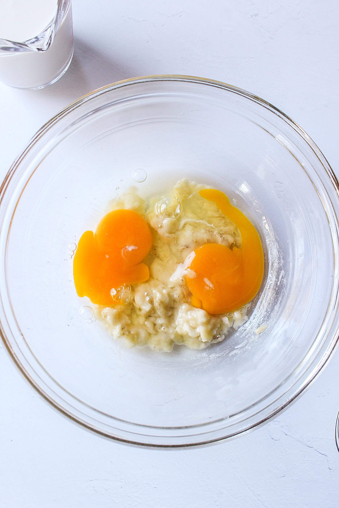 egg and banana whisked together in a bowl.