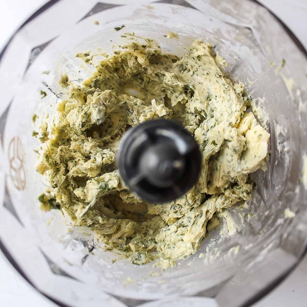 herbs and butter in a food processor