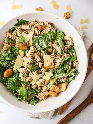 caesar salad with pasta in a serving bowl
