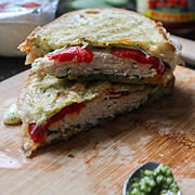 a panini sandwich stacked on top of each other on a cutting board