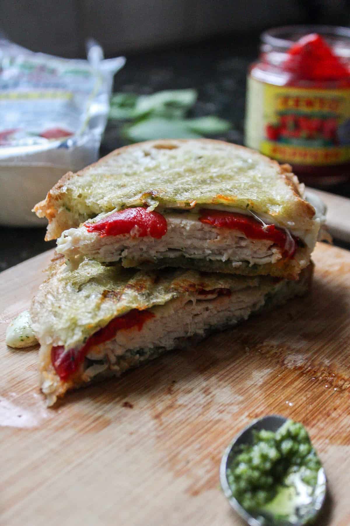 a panini sandwich stacked on top of each other on a cutting board
