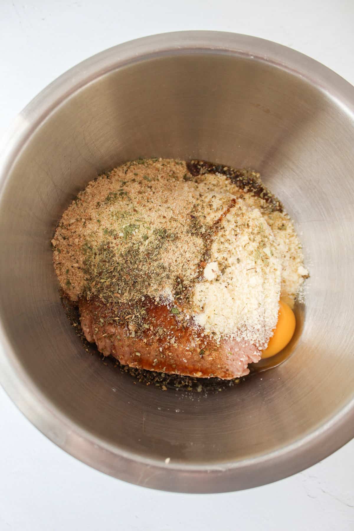 ingredients for a garlic herb chicken loaf in a bowl
