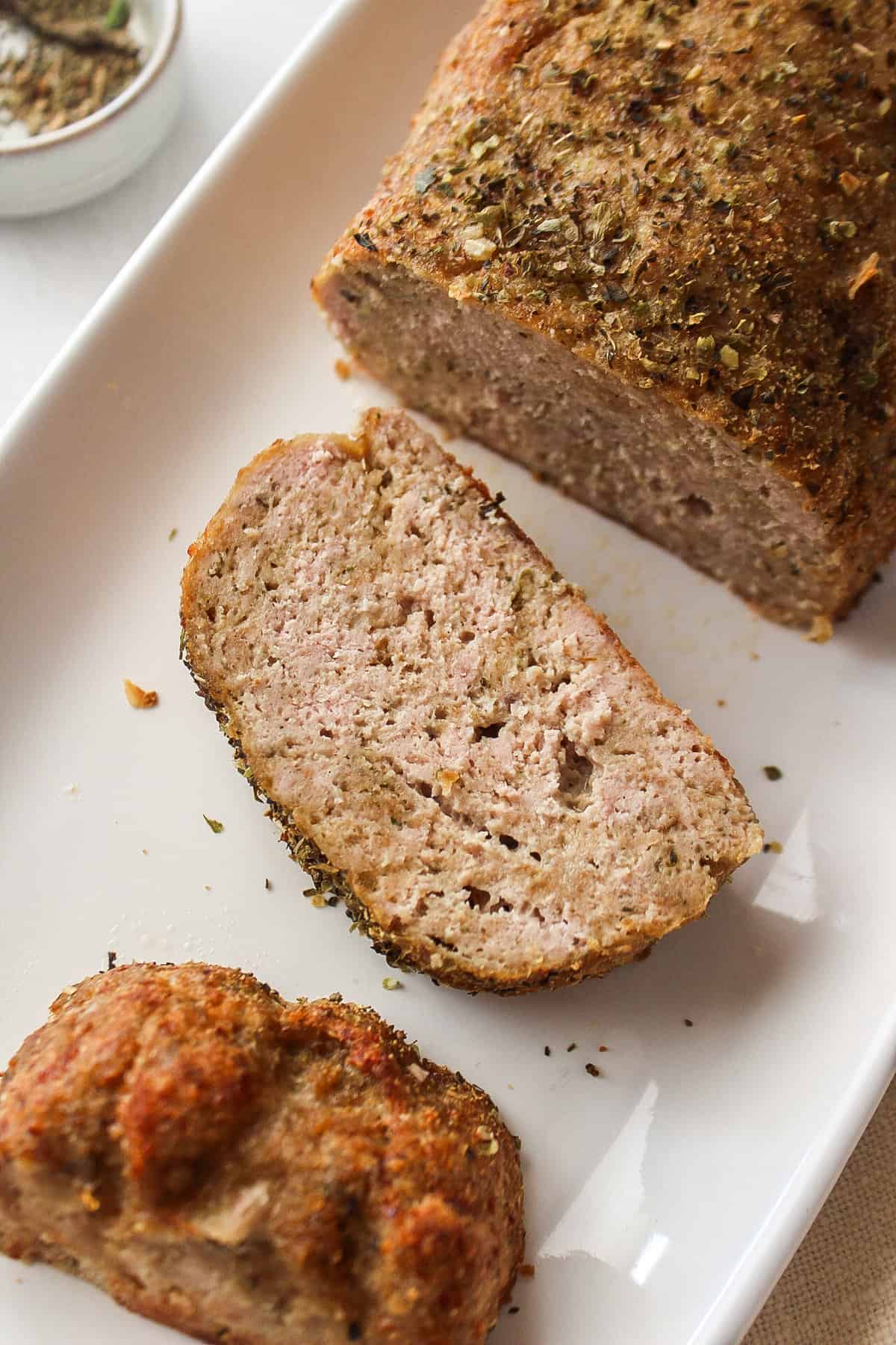 baked garlic herb chicken meatloaf on a plate