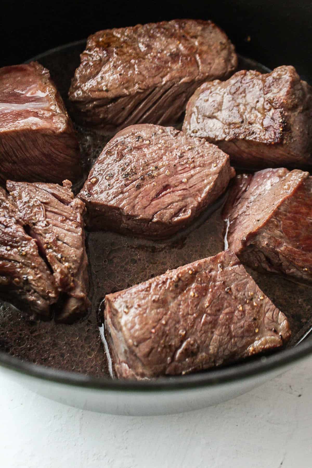 red wine in a dutch oven with short ribs.