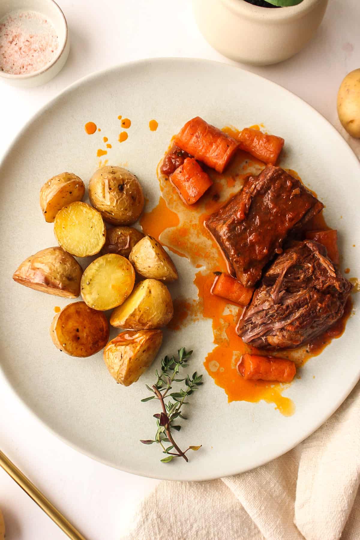 boneless braised short ribs on a plate with carrots and potatoes