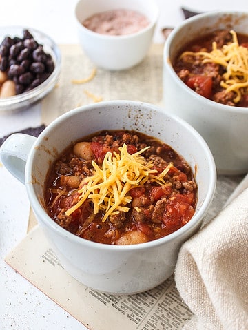 ground beef chili in a mug with cheese on top