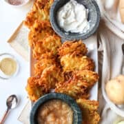 potato latkes on a plate with applesauce and sour cream