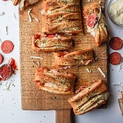 stuffed pizza braid with three cheese and pepperoni on a cutting board