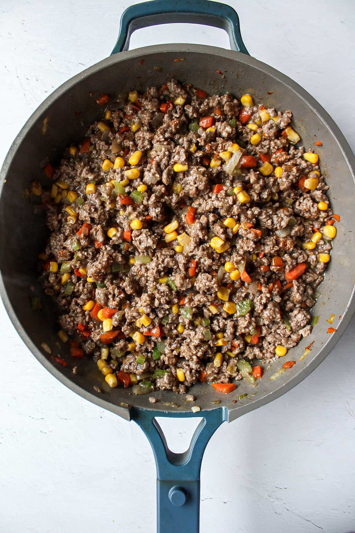 ground meat with veggies in a skillet.