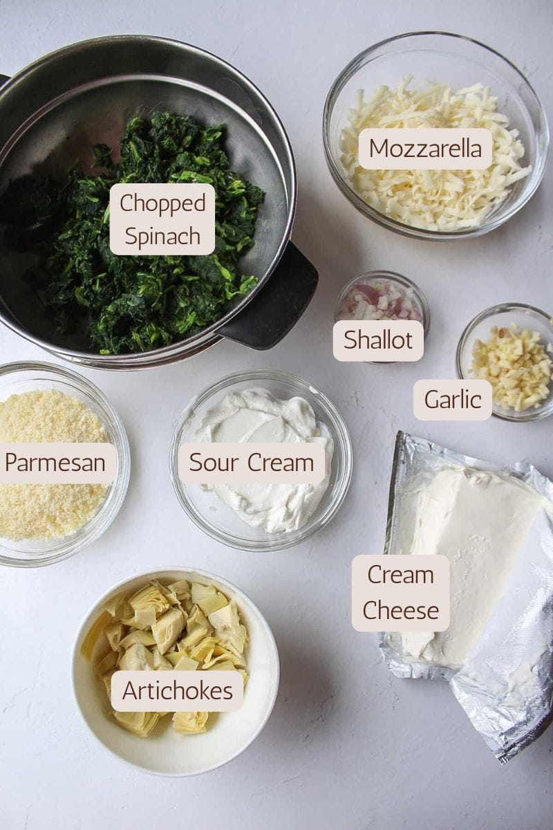 Ingredients to make a cheesy baked spinach artichoke dip.