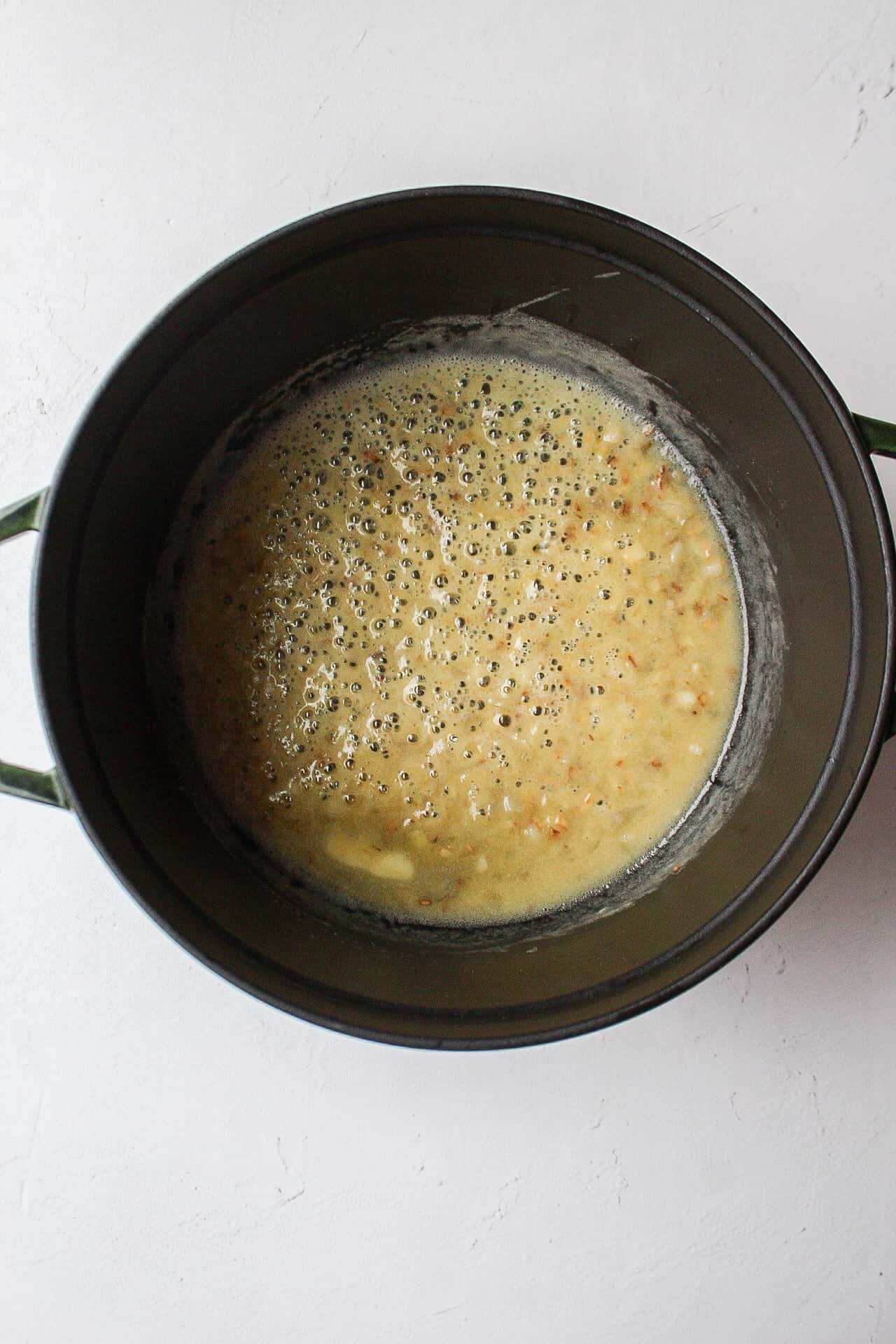 butter and flour whisked together in a dutch oven to make a roux for broccoli cheddar soup
