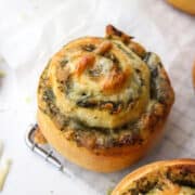 pesto pizza pinwheel on parchment paper