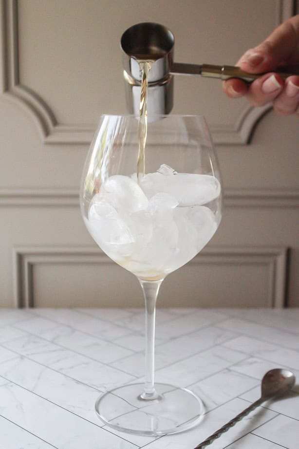 st germain poured into a glass with ice.