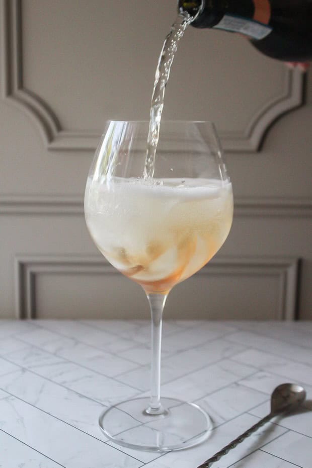 pouring prosecco into a glass.