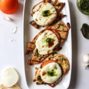 grilled chicken caprese on a platter.