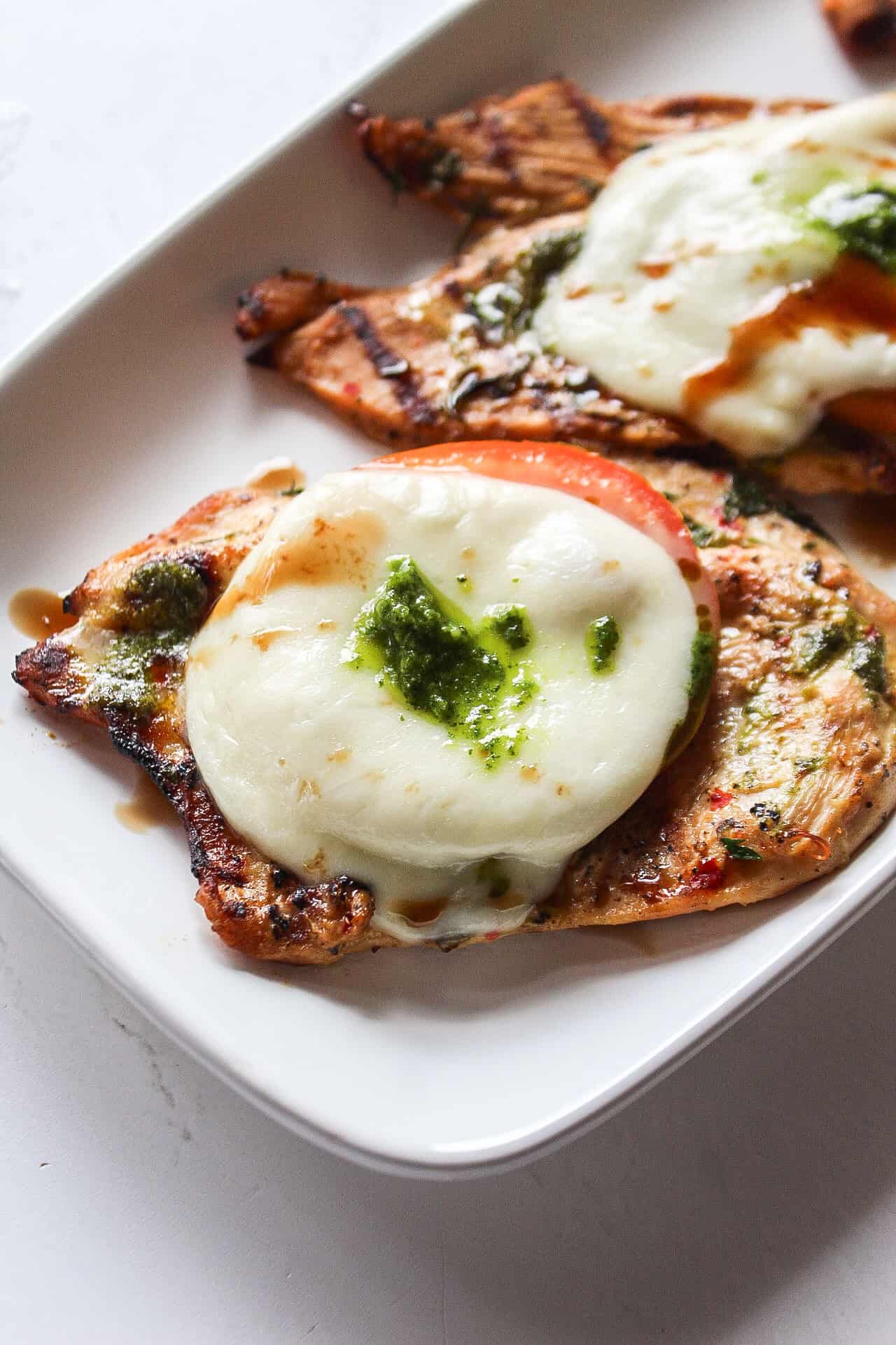 grilled chicken caprese on a platter.