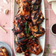 grilled teriyaki chicken thighs on a plate.