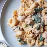 chicken tortellini pasta on a plate with spinach