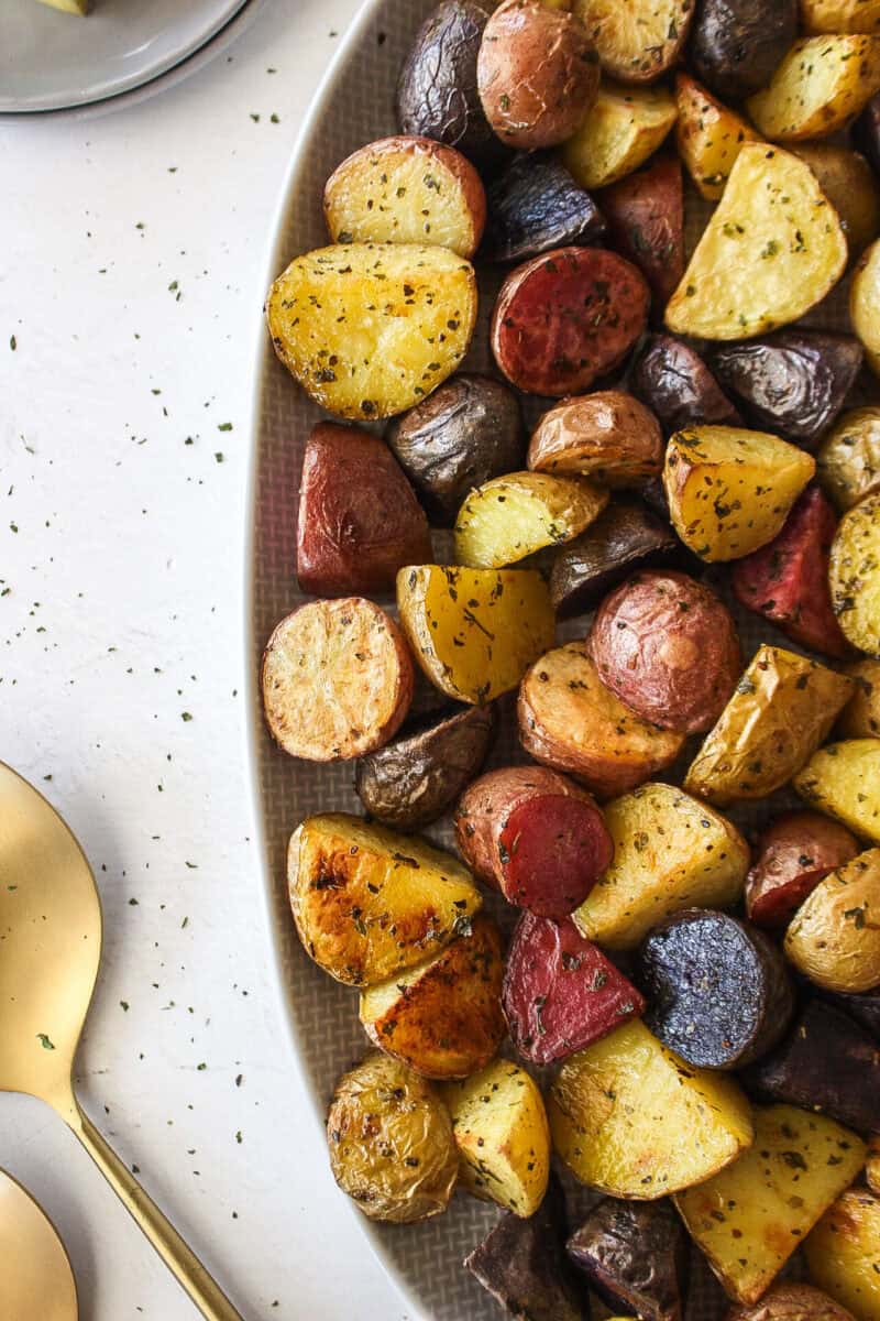 close up of roasted rainbow baby potatoes on a platter.