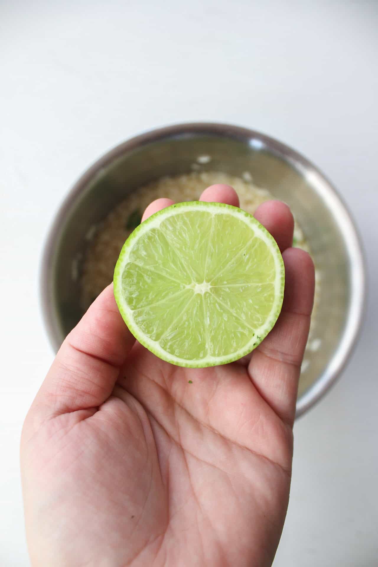 A half of a lime over a pot of white rice.