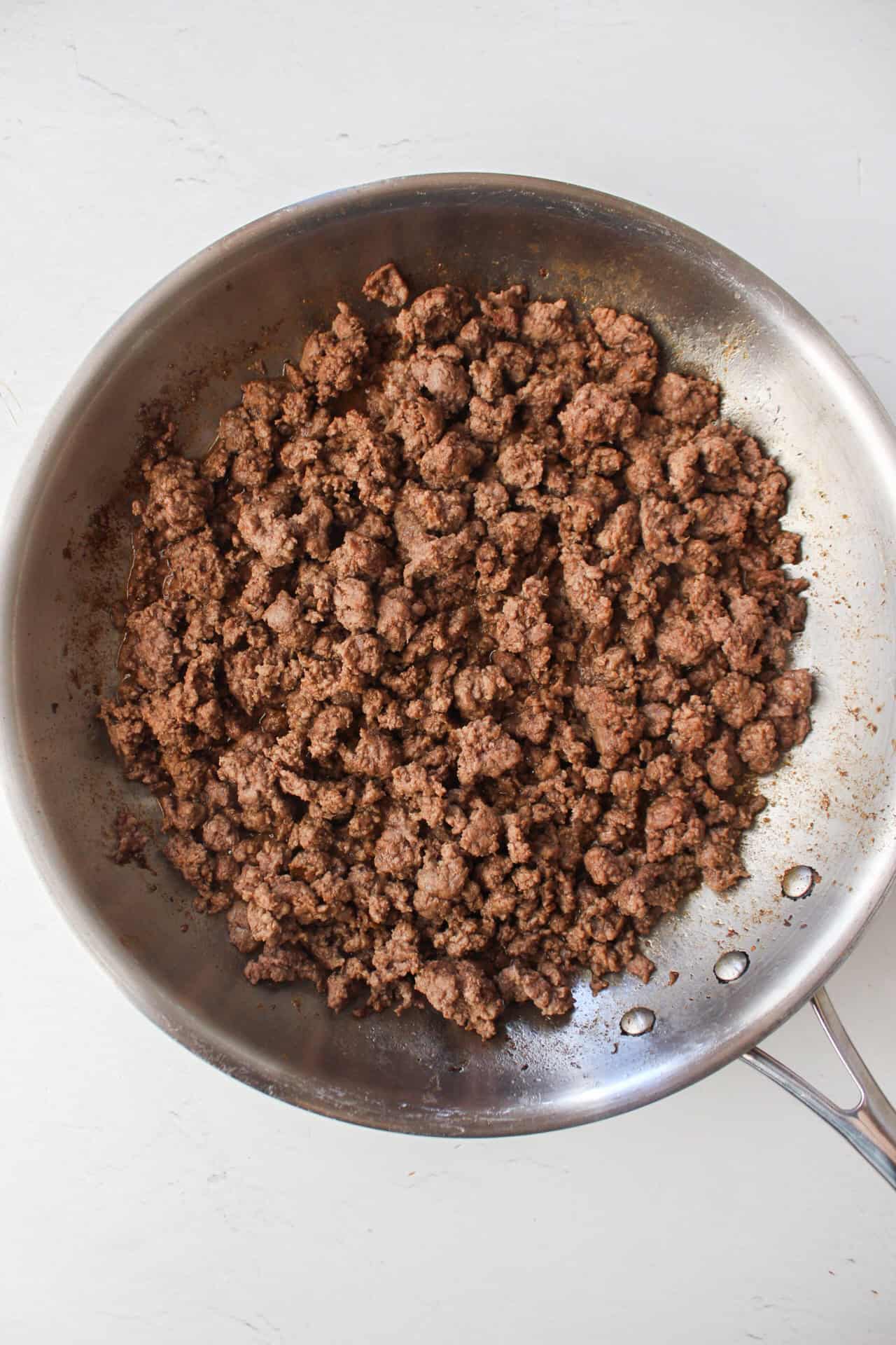 Cooked ground beef in a saute pan.