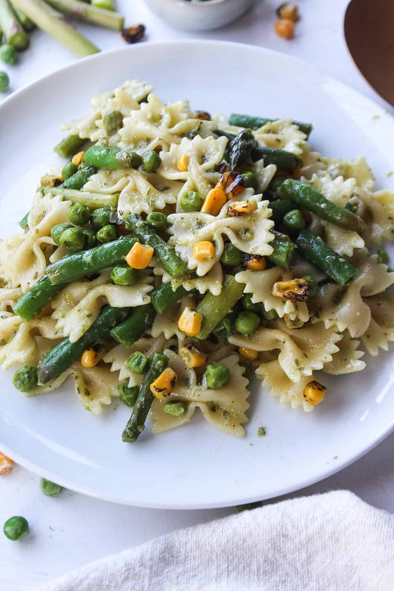 Close up of a plate of a spring veggie pasta salad.