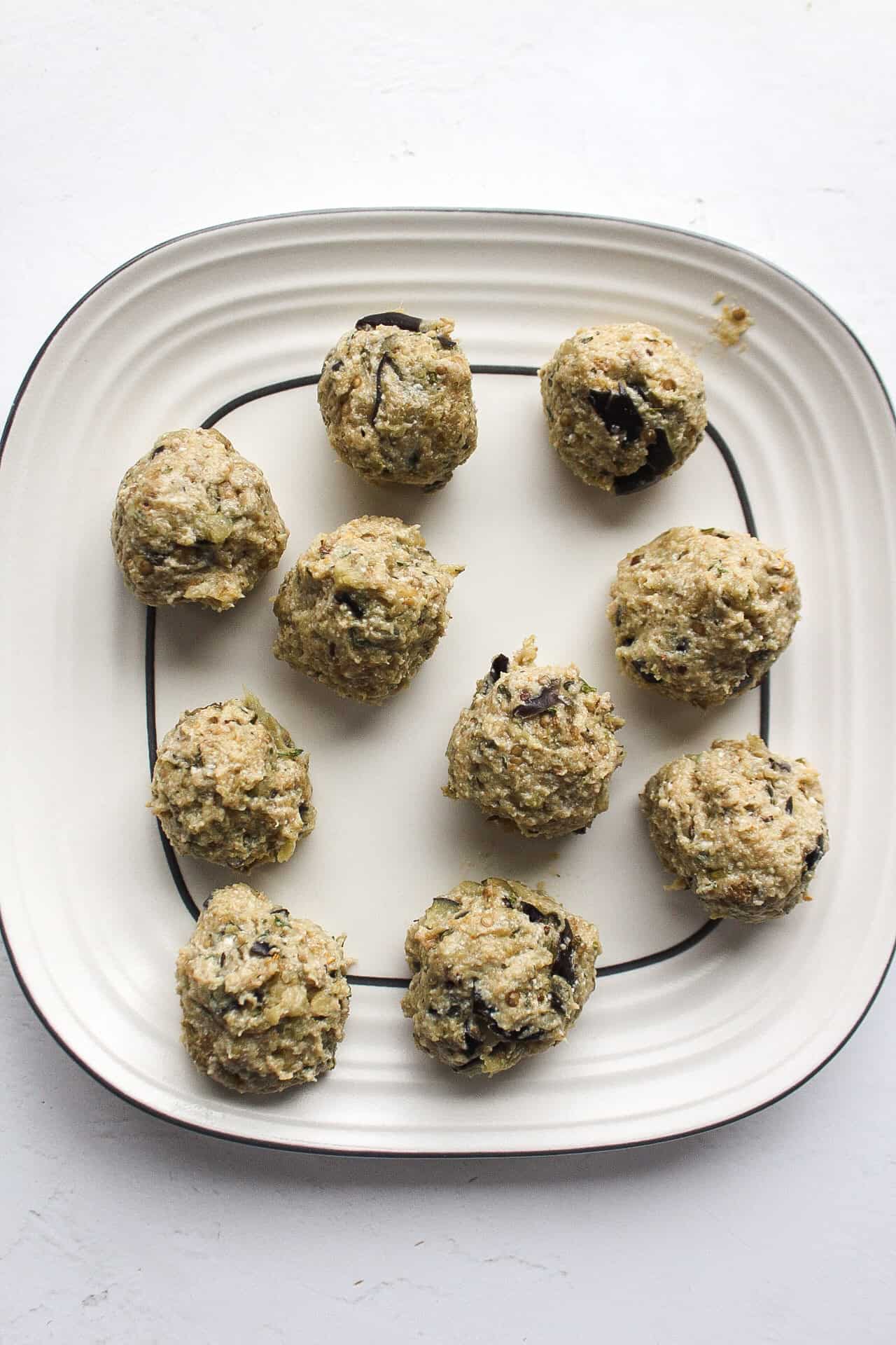 Eggplant meatballs on a plate before frying.